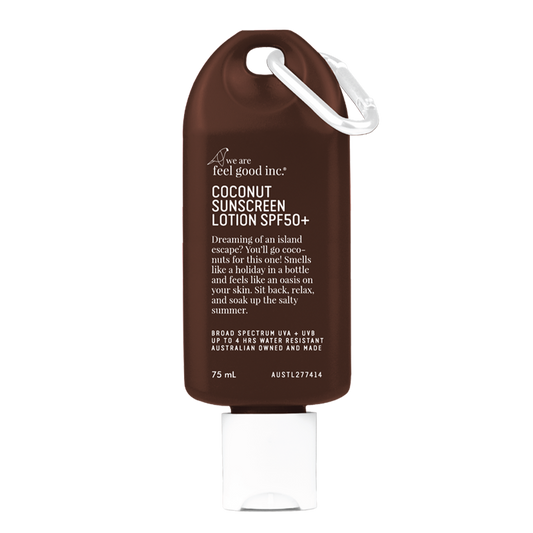 A brown 75ml bottle of 'We Are Feel Good Inc.' Coconut Sunscreen Lotion SPF50+ with a white cap and a white loop on the side for easy carrying