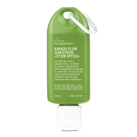 A olive green-coloured 75ml bottle of 'We Are Feel Good Inc. Kakadu Plum Sunscreen Lotion SPF50+' with a white cap and loop for easy carrying.