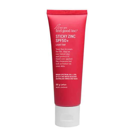 A 50g red plastic tube of We Are Feel Good Inc. Sticky Zinc SPF50+ in the shade light tint