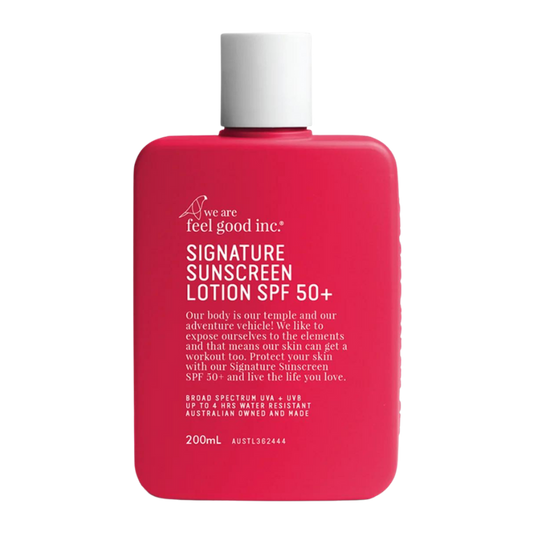 A red 200ml bottle of 'We Are Feel Good Inc Signature Sunscreen Lotion SPF 50+' with a white lid